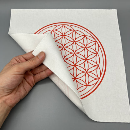 12 Inch Flower of Life Crystal Grid Cloth Being Held Up to Show the Black Back Side and Flower of Life Symbol Showing Through Slightly